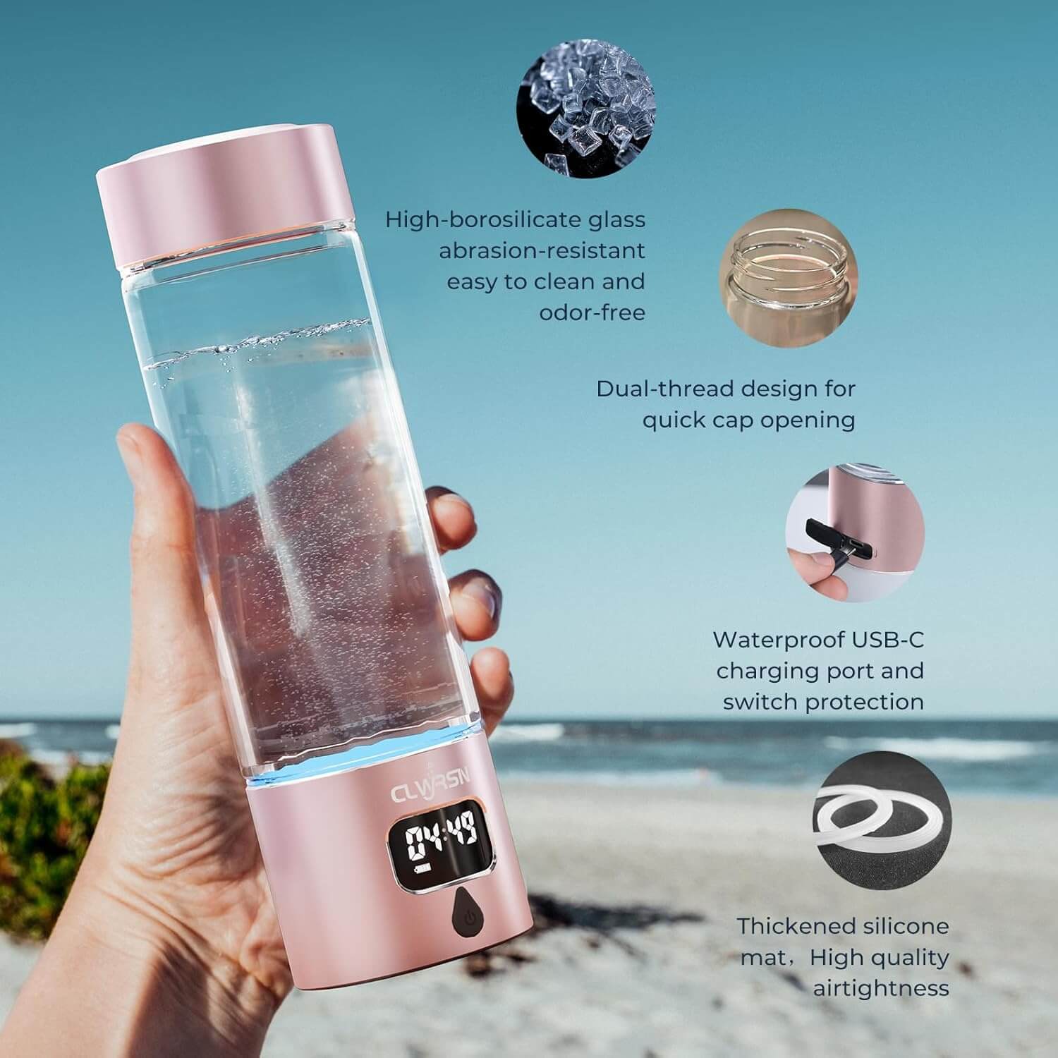 Person holding a pink glass hydrogen water bottle by the beach, showcasing features like high-borosilicate glass and USB-C charging port.