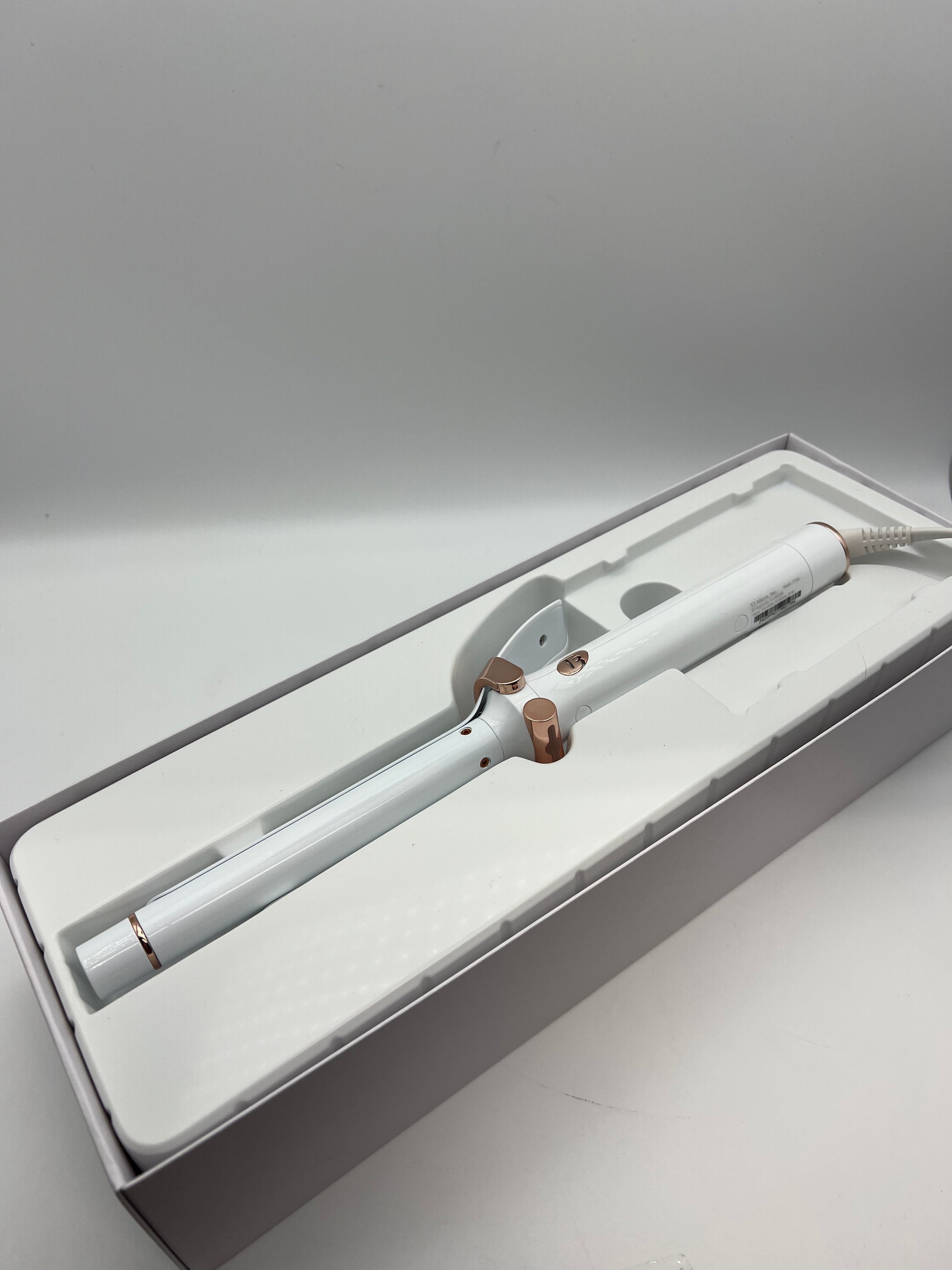 white and rose gold curling iron