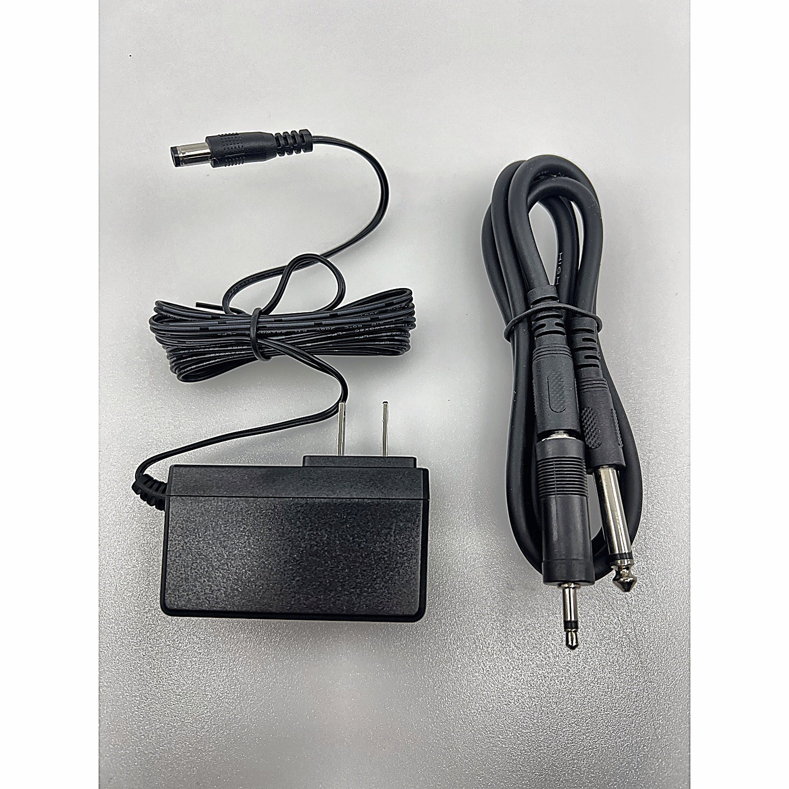 Phenyx Pro power adapter and quarter-inch audio cable